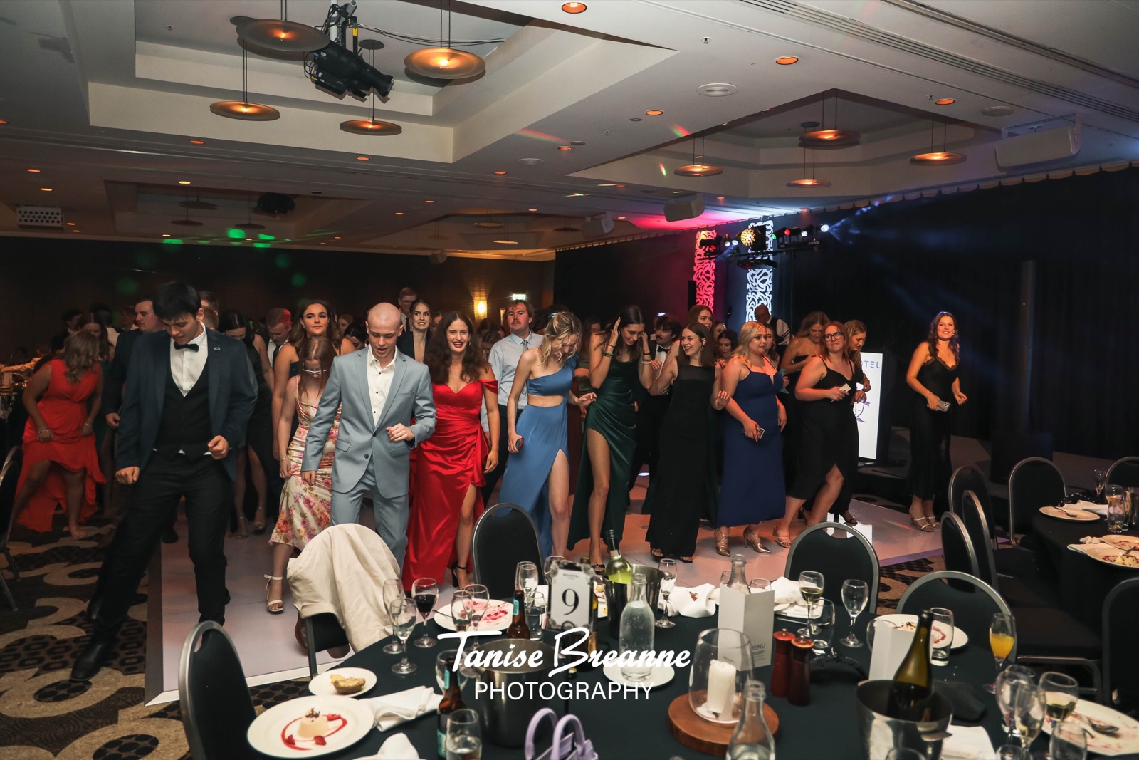 Guests at a formal event with dance floor lighting