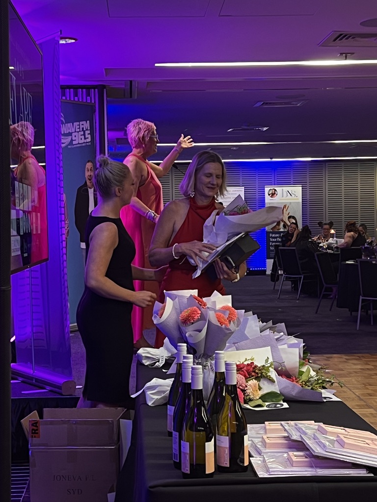 Flare Awards recipient holding flowers and a presentation box
