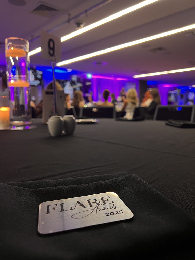 Flare Awards plaque on a candlelit guest table
