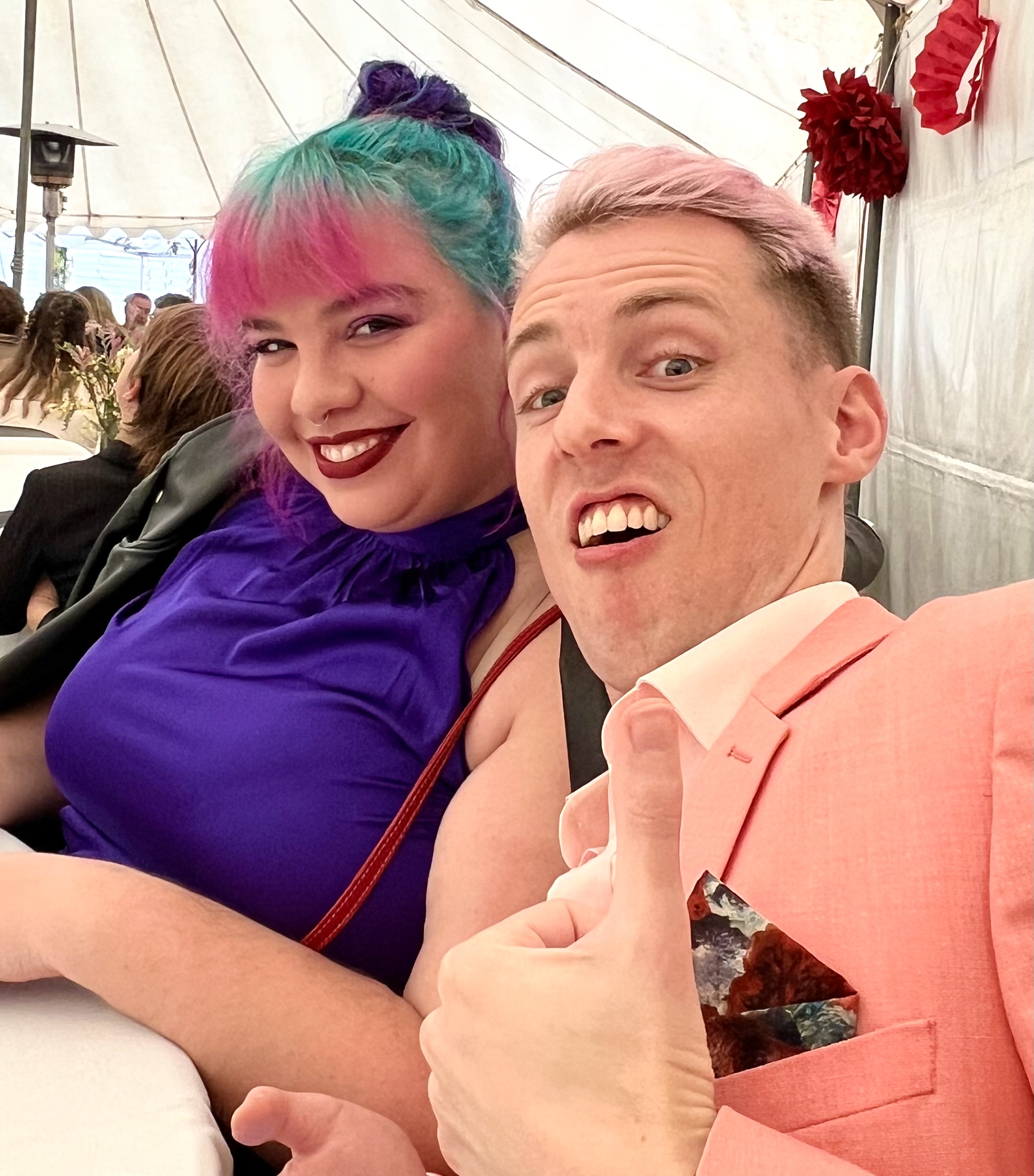 Two wedding guests smiling for a selfie