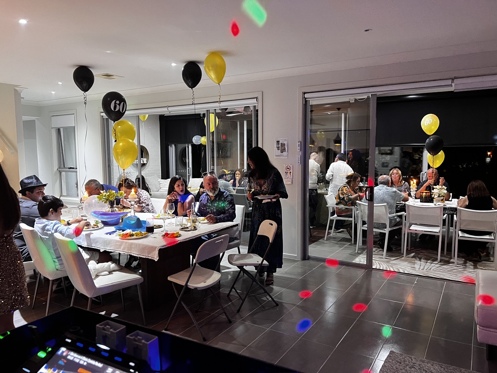Family and friends dining at the at-home 60th birthday