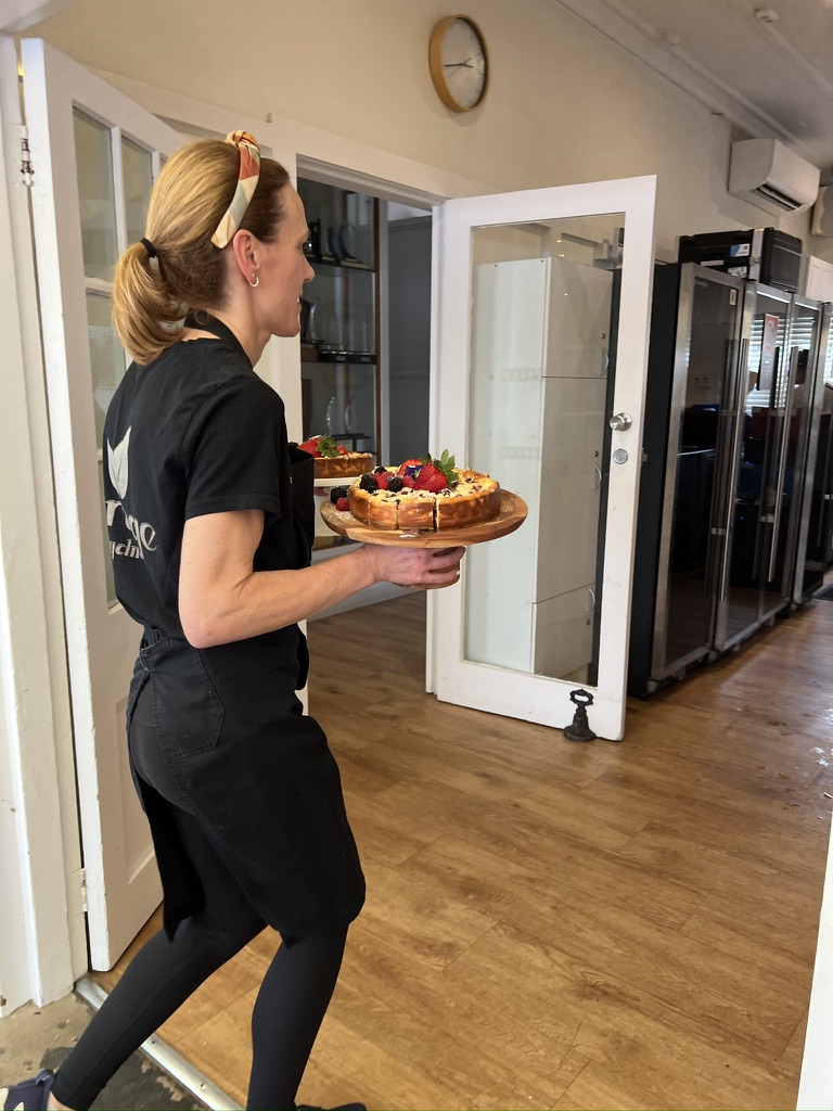 Caterer carrying berry-topped desserts