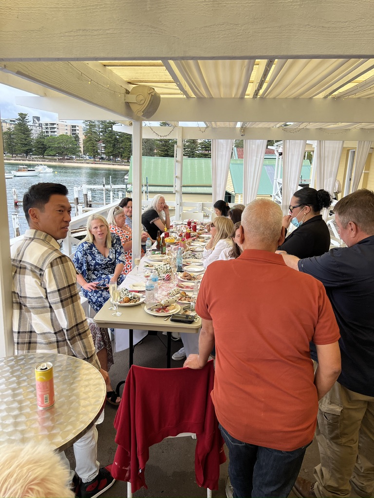 Guests dining on the terrace overlooking the harbour