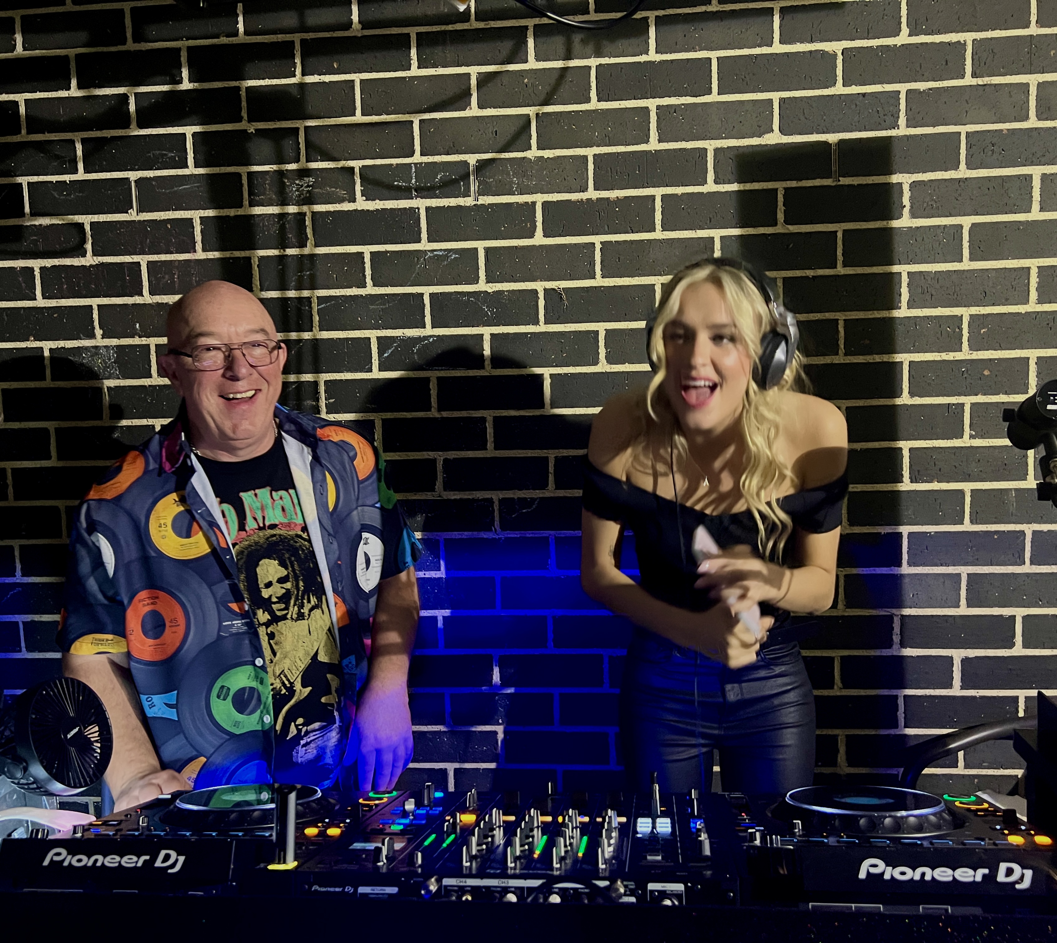 AMPT Australia and another DJ smiling behind the Pioneer DJ setup