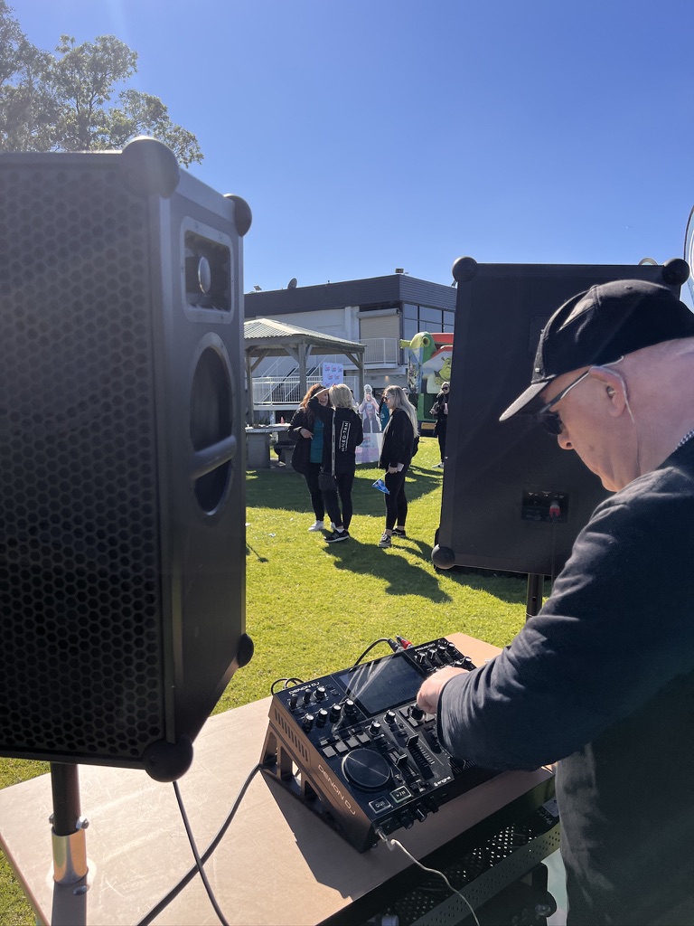 AMPT Australia adjusting the Denon DJ controller outdoors