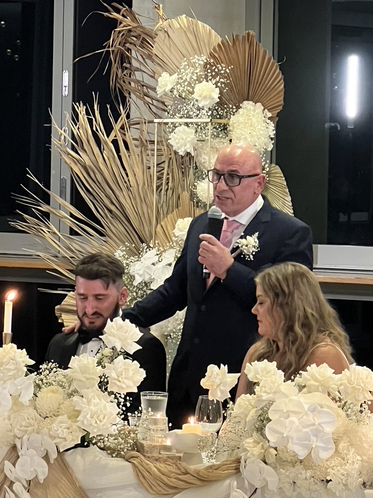AMPT Australia delivering a wedding speech beside Jonathan and Caitlin