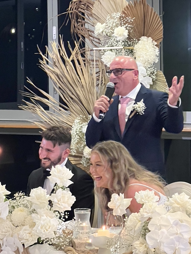 Jonathan and Caitlin laughing together during the reception
