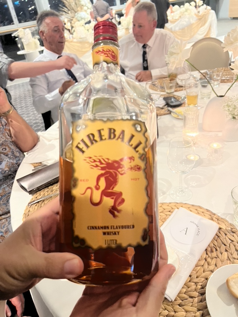 A Fireball bottle held up during the wedding reception
