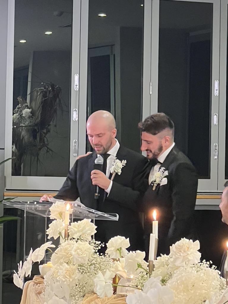 A member of the wedding party speaking beside Jonathan