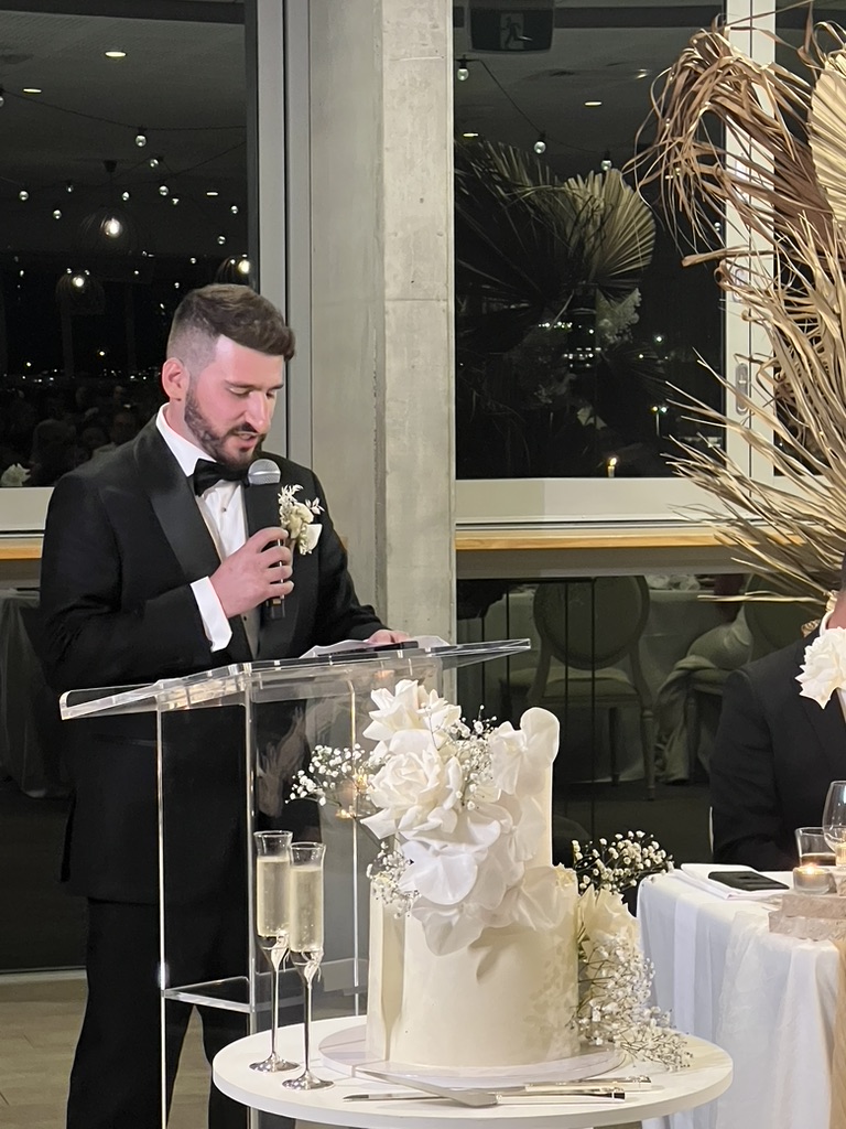 Jonathan speaking with the wedding cake in the foreground