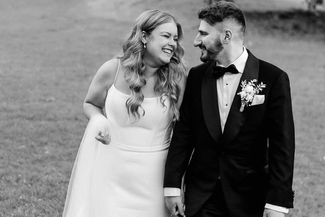Jonathan and Caitlin laughing together on their wedding day